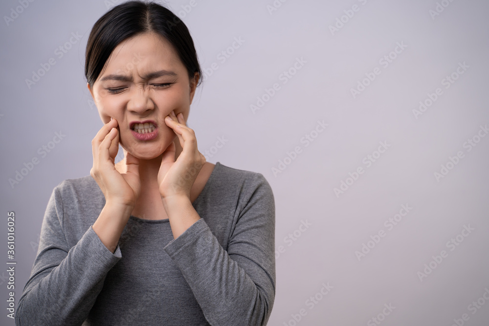 Asian woman was sick with toothache standing isolated on background. Asian woman was sick with toothache standing isolated on background.