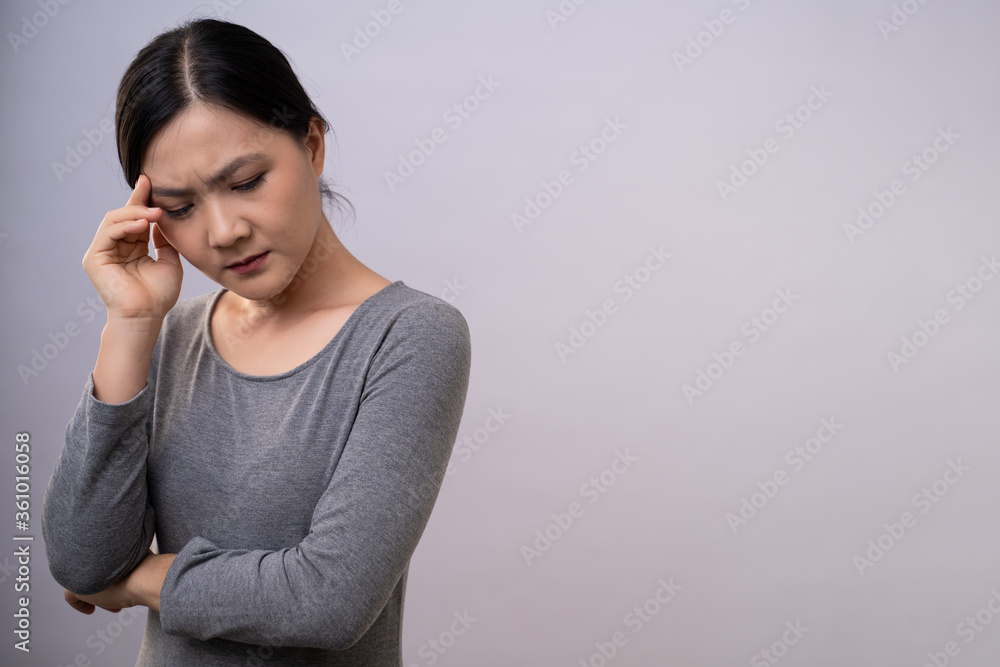Asian woman was sick with headache standing isolated on background. Asian woman was sick with headache standing isolated on background.