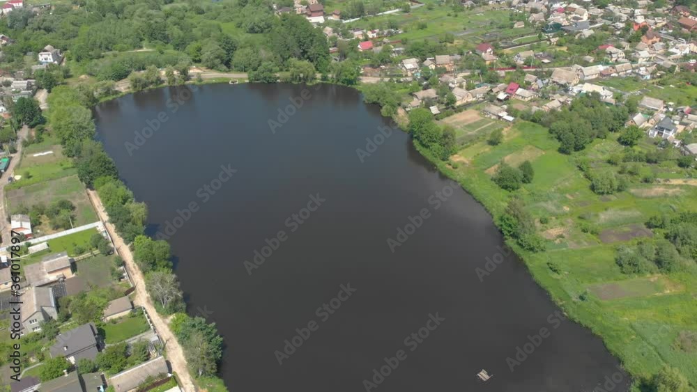 Lakes in the village summer green trees forest aerial drone view right side flying around tilt up camera movement Lakes in the village summer green trees forest aerial drone view right side flying around tilt up camera movement