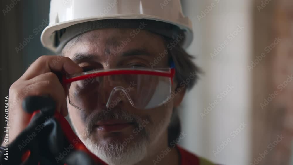 Portrait of mature builder with dirty face on construction site Portrait of mature builder with dirty face on construction site