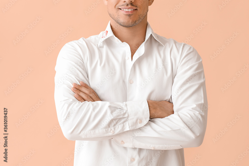 Young businessman with lips print on shirt collar against color background Young businessman with lips print on shirt collar against color background