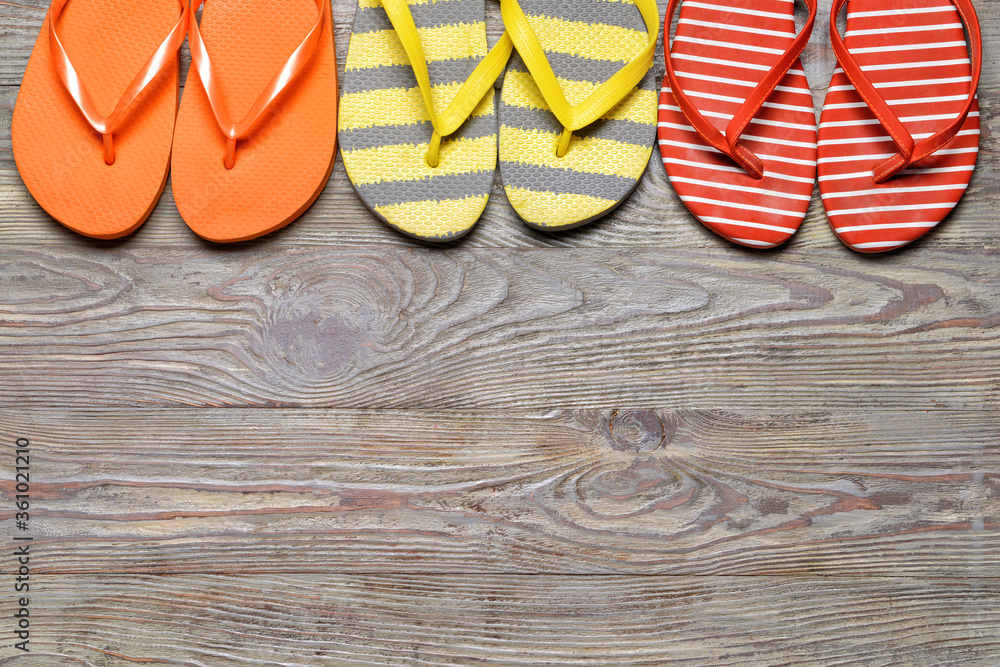 Stylish flip-flops on wooden background Stylish flip-flops on wooden background