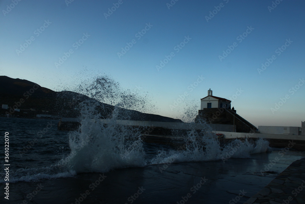 Waves at the small harbour in front of the Chapel of Panagia Thalassini at Andros, Greece 