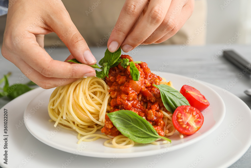 Woman cooking tasty pasta bolognese, closeup Woman cooking tasty pasta bolognese, closeup