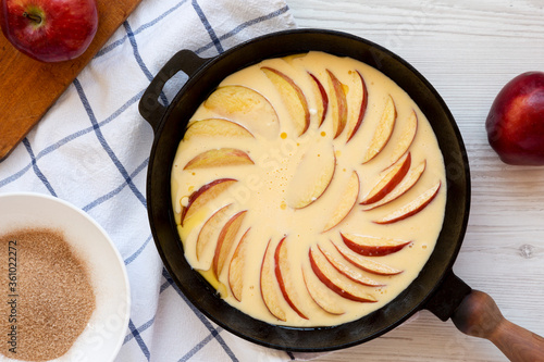 Cooking Apple Dutch Pannekoek Pancake on a white wooden background, top view. Overhead, from above, flat lay.