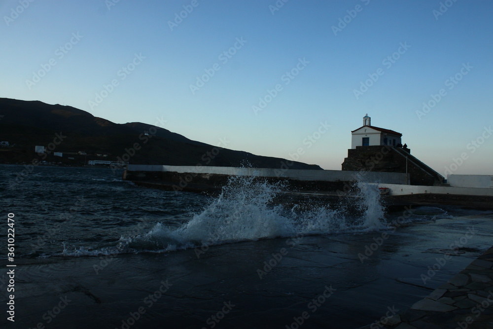 Waves at the small harbour in front of the Chapel of Panagia Thalassini at Andros, Greece 