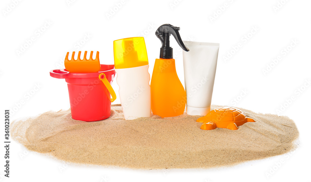 Sunscreen cream with beach sand toys on white background Sunscreen cream with beach sand toys on white background