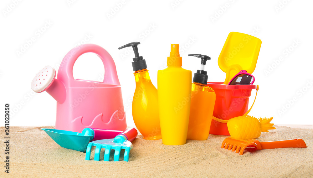 Sunscreen cream with beach sand toys on white background Sunscreen cream with beach sand toys on white background