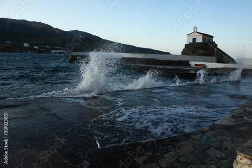 Waves at the small harbour in front of the Chapel of Panagia Thalassini at Andros, Greece 