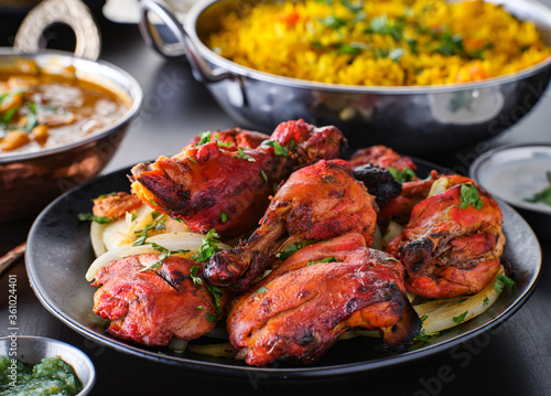 indian tandoori chicken with onions and cilantro photo