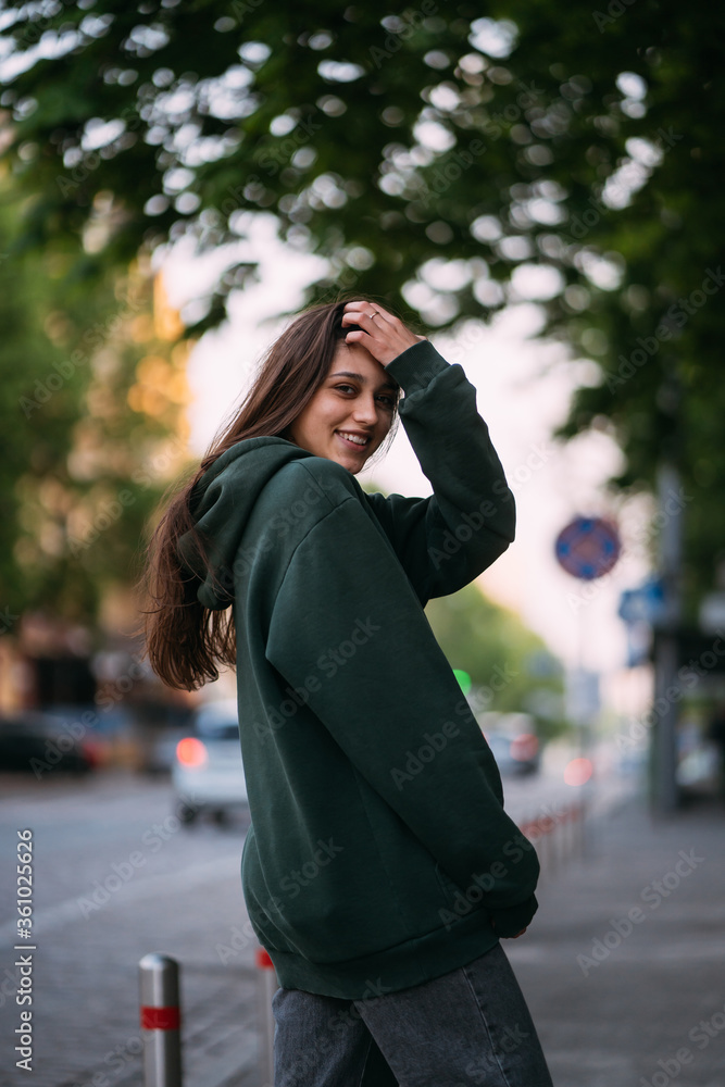 Portrait of cute girl with long hair looks at the camera Portrait of cute girl with long hair looks at the camera