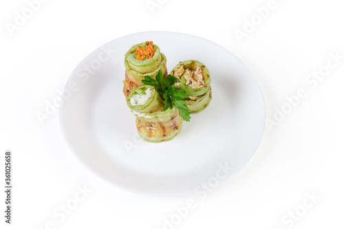 Rolls of grilled vegetable marrow with different filling on dish