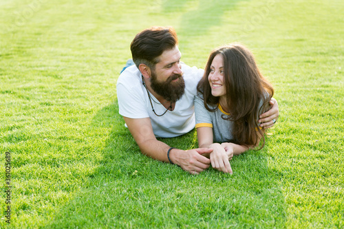 Happy summer. Happy family relax on green grass. Couple in love dating on natural landscape. Happy vacation. Family recreation. Enjoyment and relaxation. Being happy together