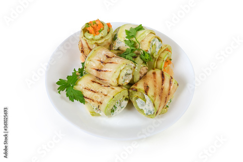 Rolls of grilled vegetable marrow with different filling on dish