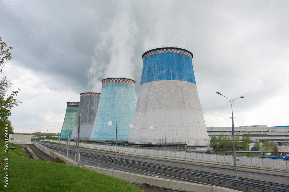 Cooling towers of a thermal power plant on a sunny summer day. Cooling towers of a thermal power plant on a sunny summer day.