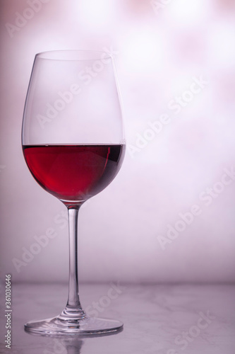 glass of red wine on blurred background