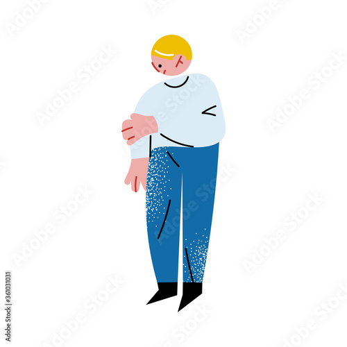 Bullied afraid boy standing and touching injuried hand