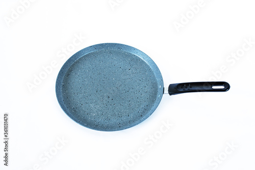 Round cast iron griddle pan isolated on white. Pancake pan isolated on white background.