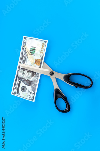 Decline of dollar exchange rate. Scissors cut dollars banknote