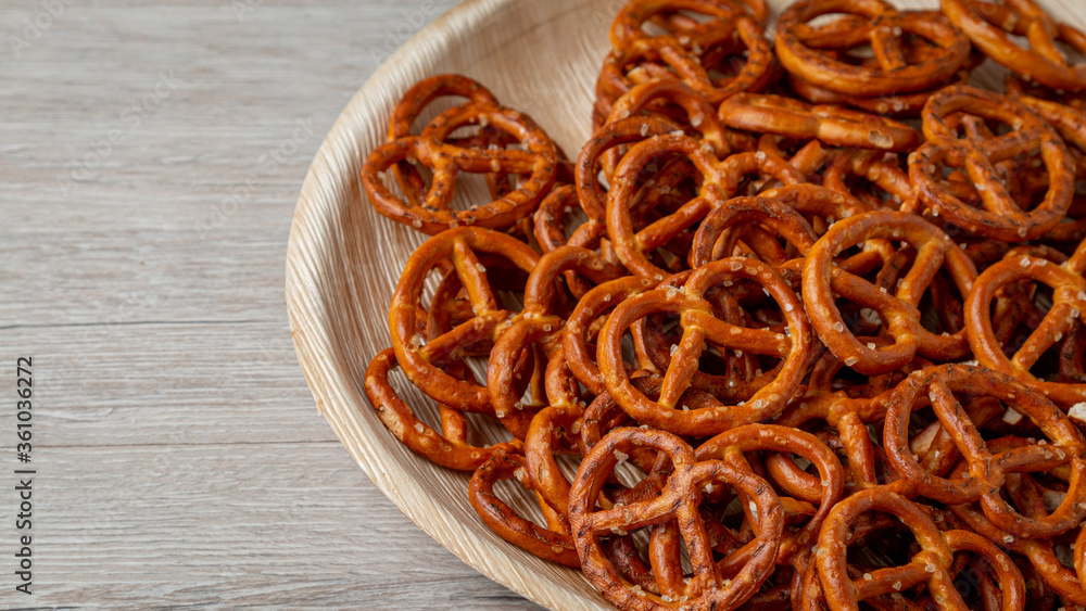 Pretzels on a plate on the kitchen table. Snack on beer. Salty snack. Crispy pretzels. Pretzels on a plate on the kitchen table. Snack on beer. Salty snack. Crispy pretzels.