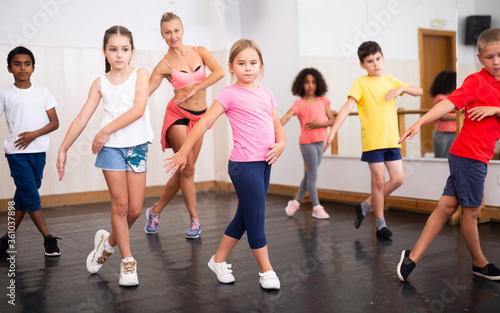 Boys and girls training in dance studio