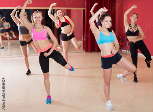 Glad active females exercising dance moves