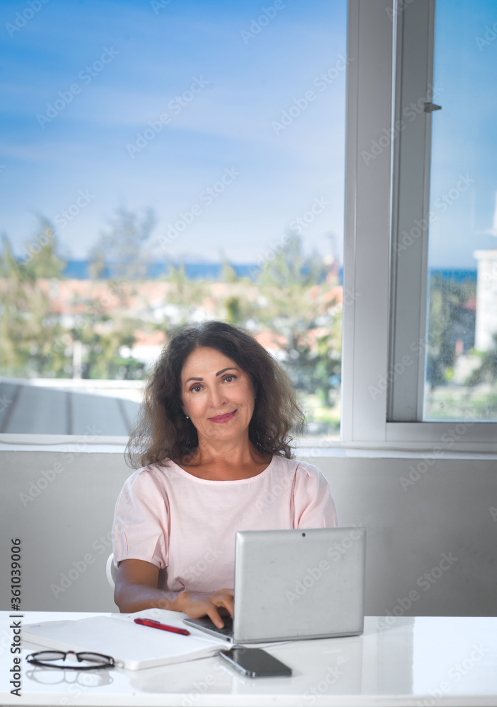 Portrait of a beautiful senior woman working at home Portrait of a beautiful senior woman working at home