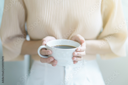 Cup of coffee. Woman drinking tea or coffee. White cup of hot beverage in the morning.