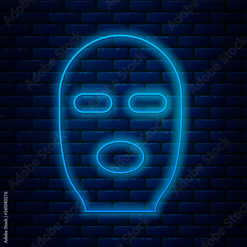 Glowing neon line Thief mask icon isolated on brick wall background. Bandit mask, criminal man. Vector Illustration.