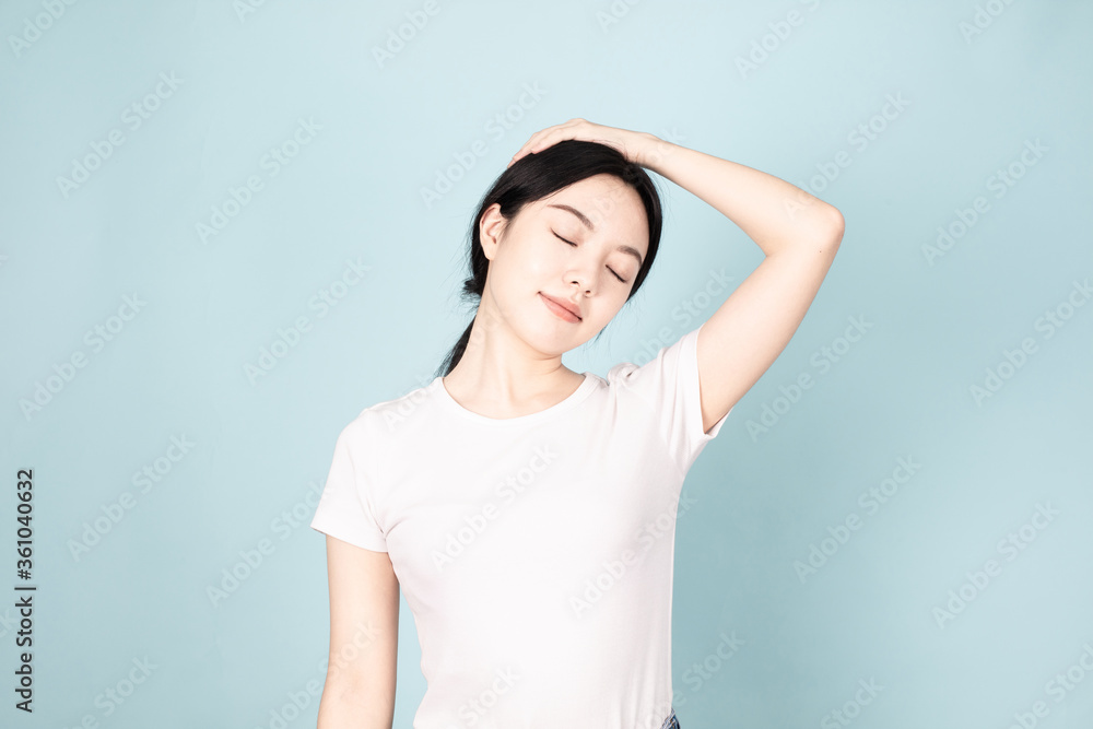 A young chinese woman in front of blue background A young chinese woman in front of blue background