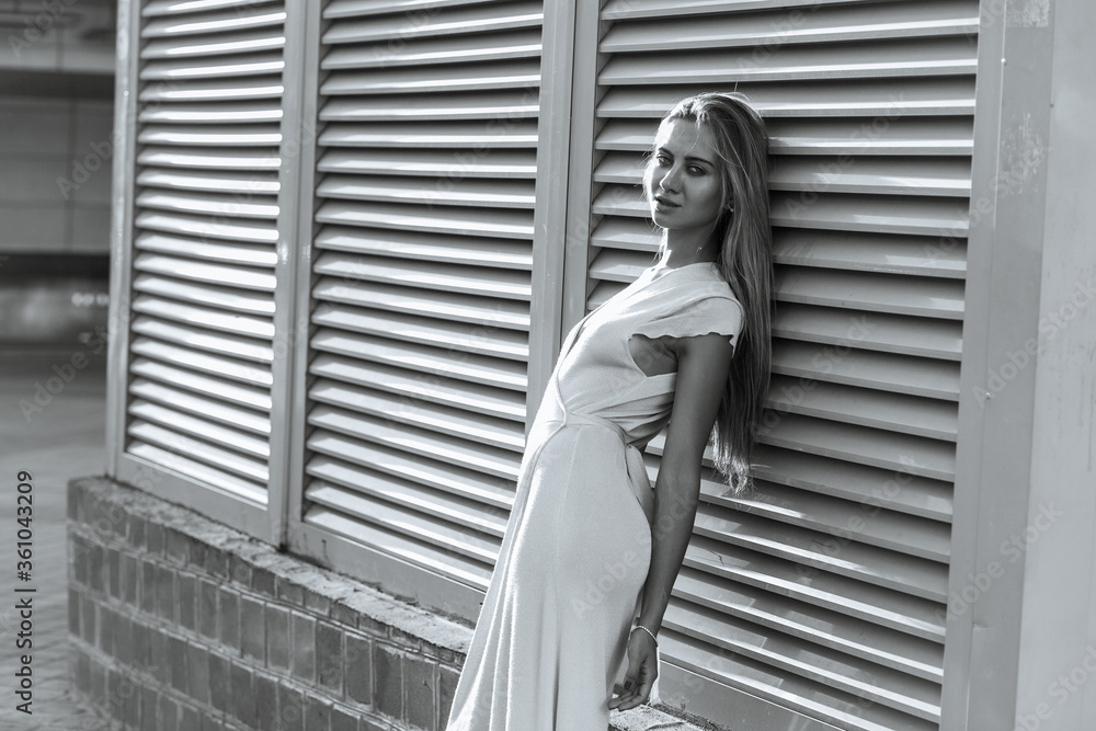 Stylish dressed girl posing at the street