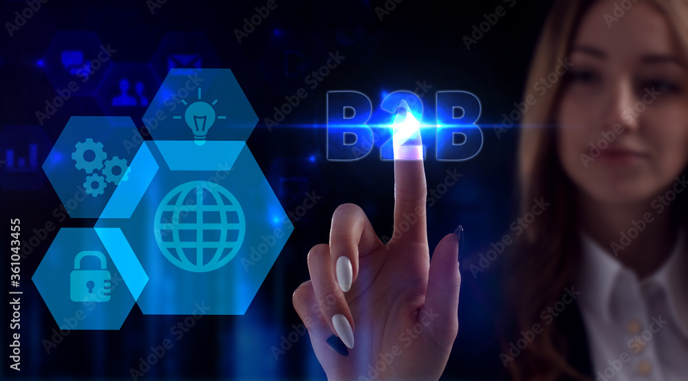 Business, Technology, Internet and network concept. Young businessman working on a virtual screen of the future and sees the inscription: B2B Business, Technology, Internet and network concept. Young businessman working on a virtual screen of the future and sees the inscription: B2B