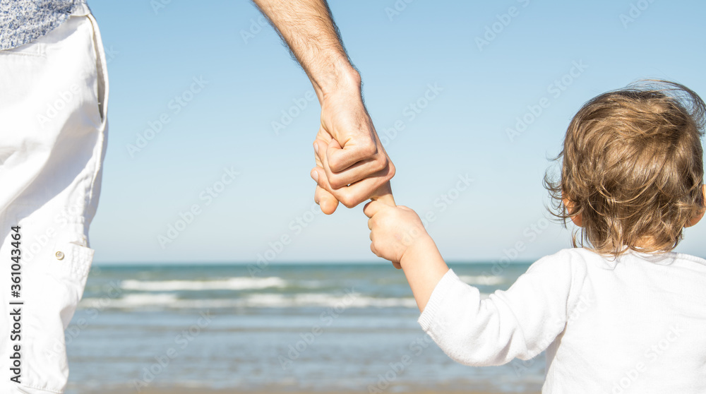Father and daughter holding hands at the beach. I love you Dad. Family concept Father and daughter holding hands at the beach. I love you Dad. Family concept
