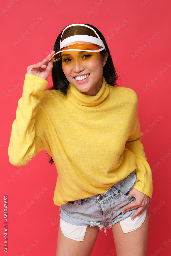 Energetic studio shoot. Asian model full of charisma and good energy wearing yellow clothes. Colorful shoot. Energetic studio shoot. Asian model full of charisma and good energy wearing yellow clothes. Colorful shoot.