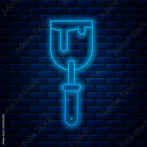 Glowing neon line Putty knife icon isolated on brick wall background. Spatula repair tool. Spackling or paint instruments. Vector Illustration.