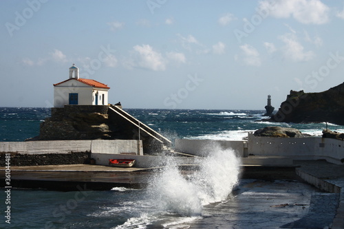 Waves at the small harbour in front of the Chapel of Panagia Thalassini at Andros, Greece  photo