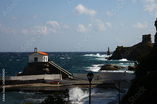 Waves at the small harbour in front of the Chapel of Panagia Thalassini at Andros, Greece  photo