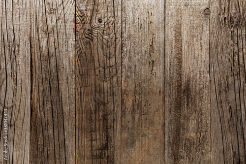 Old wooden table with cracks and scratches, aged rustic background.