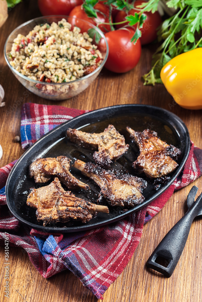 Roasted lamb chops on a roasting dish Roasted lamb chops on a roasting dish