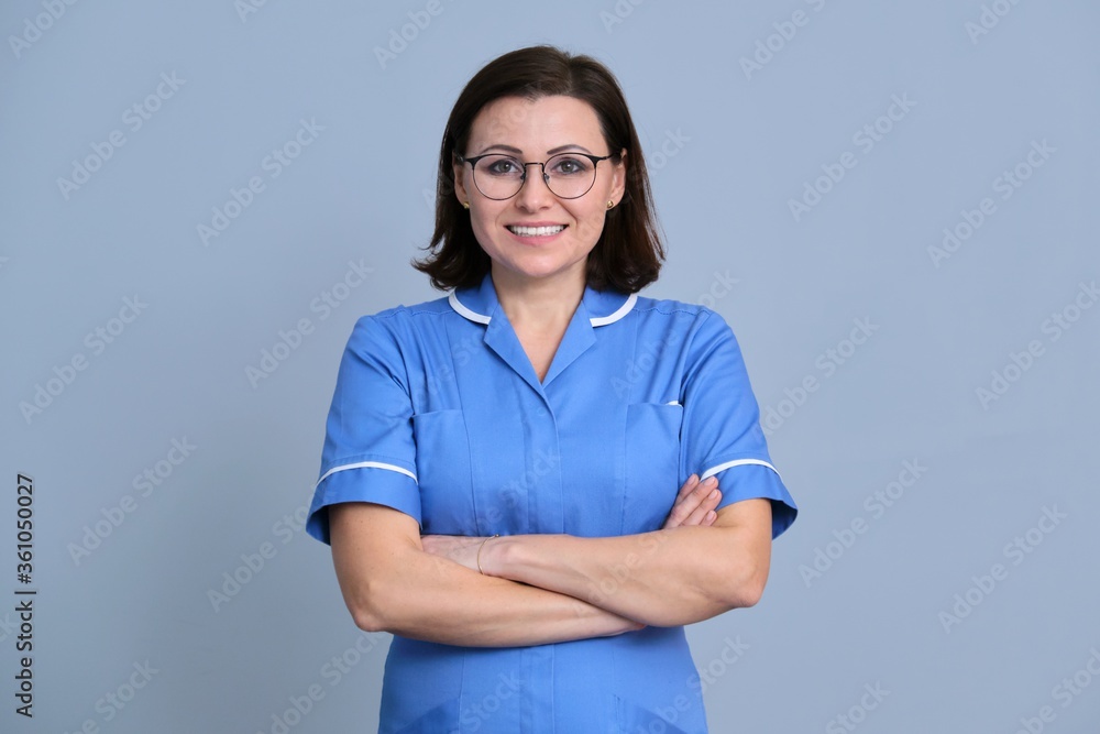 Portrait of confident smiling female nurse with arms crossed looking at camera Portrait of confident smiling female nurse with arms crossed looking at camera