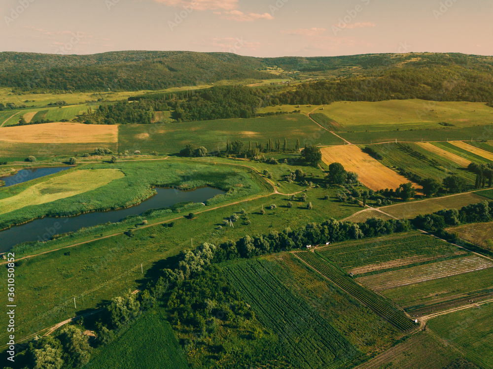 Aerial photo from drone with beautiful farmlamnd landscape at sunset in rural atmosphere.