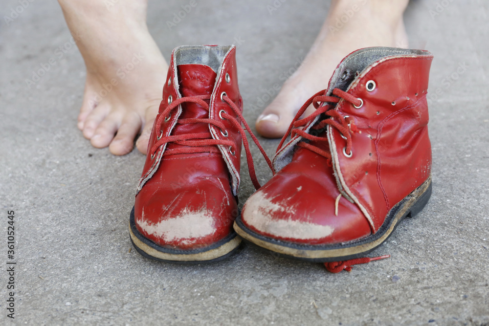old red children pair of leisure boots and woman foot old red children pair of leisure boots and woman foot