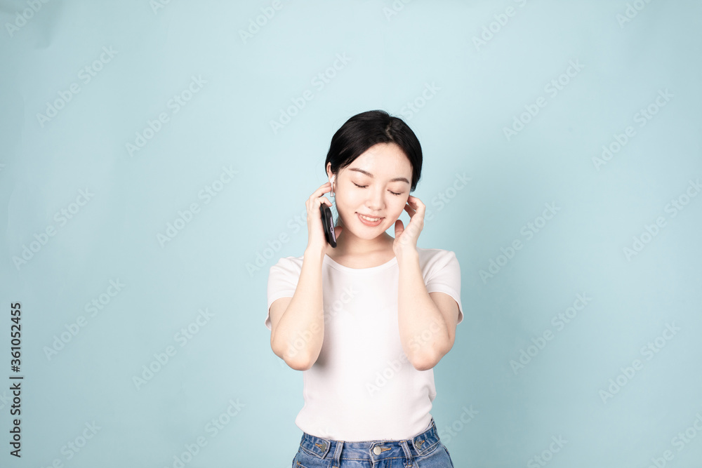 A Young Chinese Woman In Front of Blue Background A Young Chinese Woman In Front of Blue Background