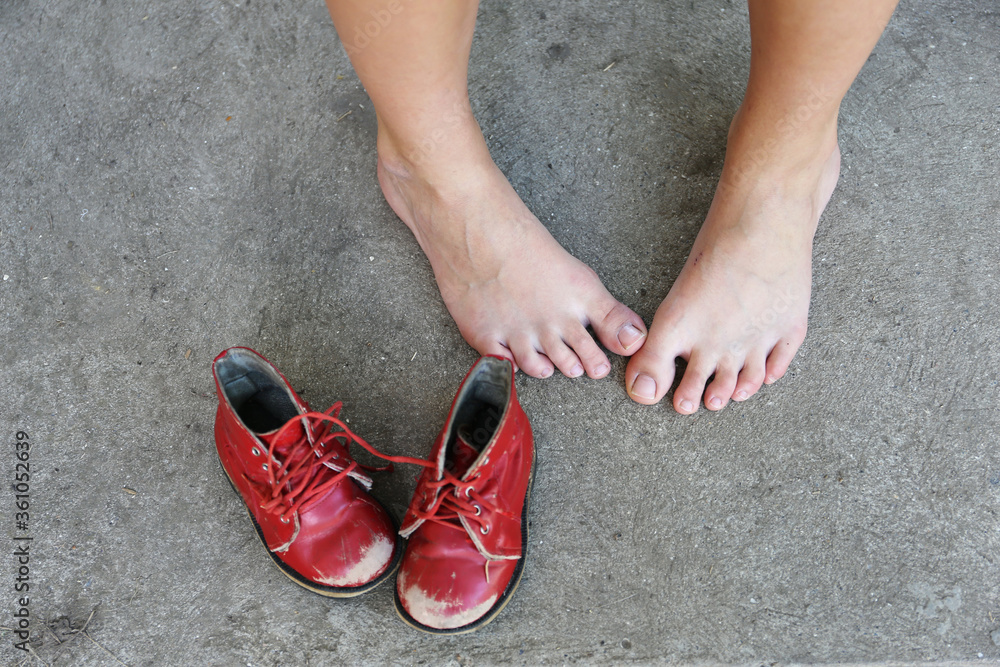 old red children pair of leisure boots and woman foot old red children pair of leisure boots and woman foot