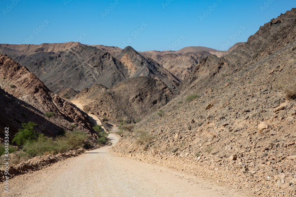 Gravel road and mountain landscape in Oman