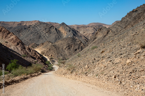 Gravel road and mountain landscape in Oman photo