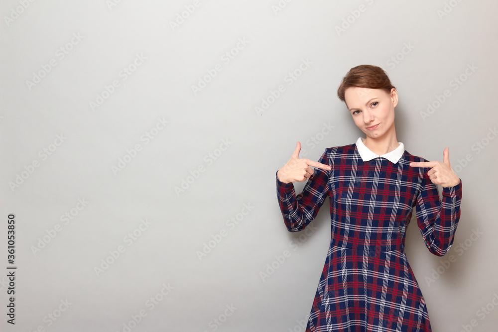 Portrait of proud and successful girl pointing with fingers at herself Portrait of proud and successful girl pointing with fingers at herself
