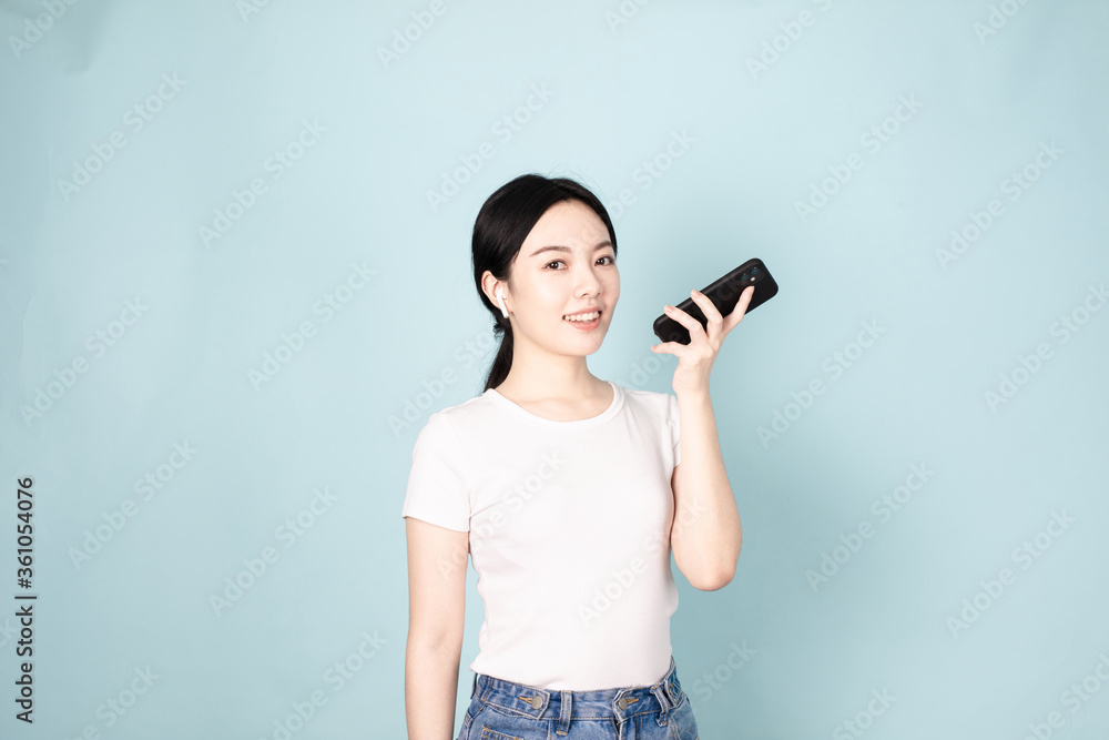 A Young Chinese Woman In Front of Blue Background A Young Chinese Woman In Front of Blue Background