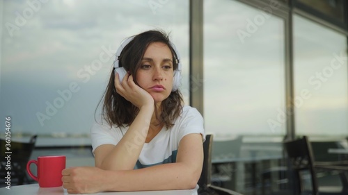 Young depressive girl in headphones listening to music Free Download Young depressive girl in headphones listening to music - GFXLoad