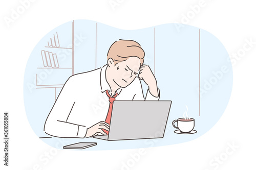 Business, frustration, mental stress, depression, work concept. Young depressed stressful frustrated businessman clerk manager working at office uses laptop. Overwork and negative emotions or headache